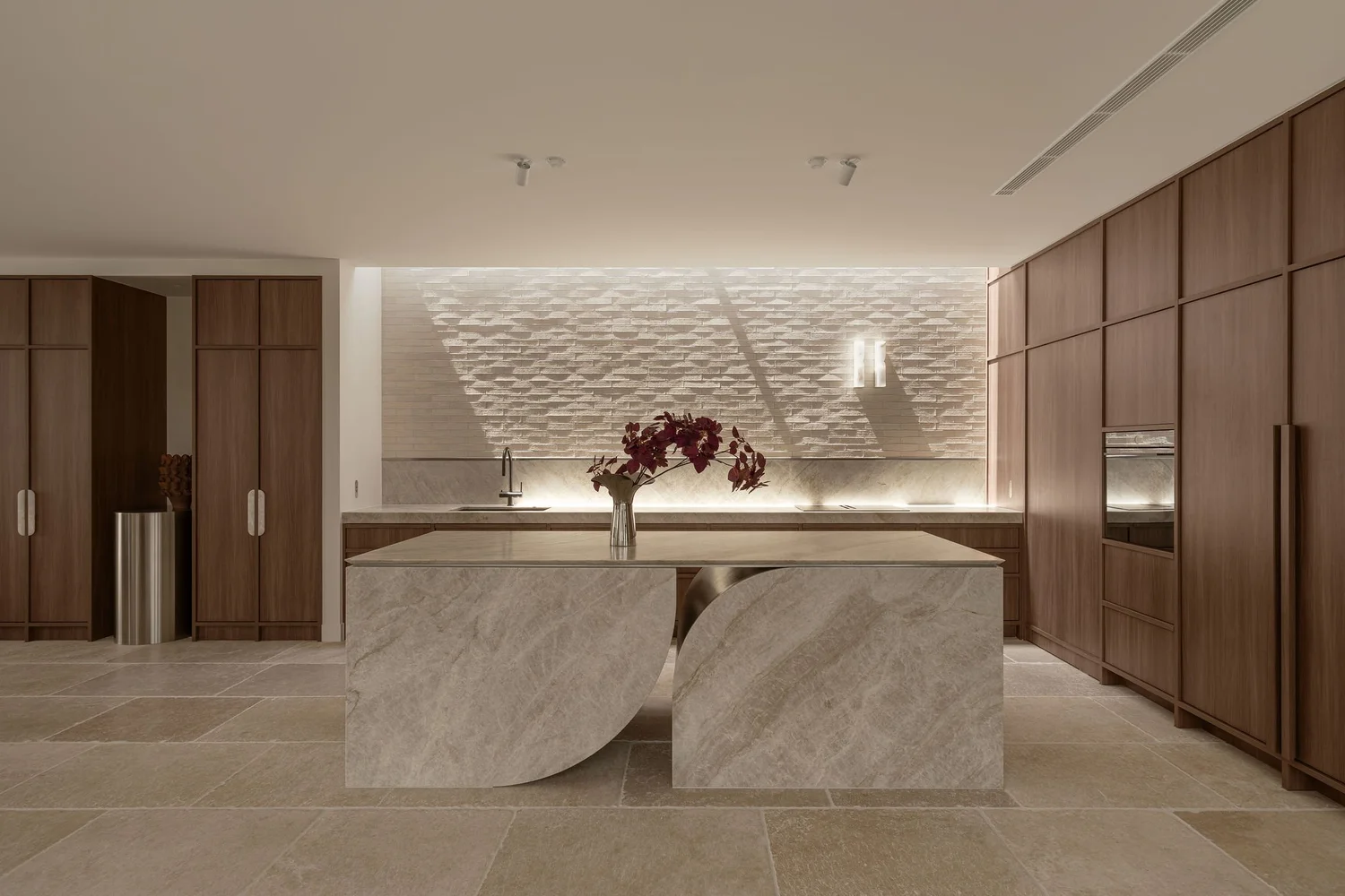 The kitchen at ZOEI with a sculptural stone island and warm timber joinery, a Gold Coast photoshoot location.