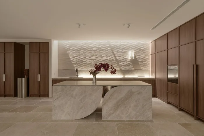 The sculptural stone island in the ZOEI kitchen, part of the Hero Spaces package.