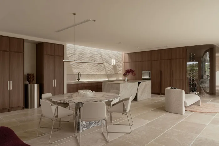 The dining table and sculptural chairs beside the ZOEI kitchen.