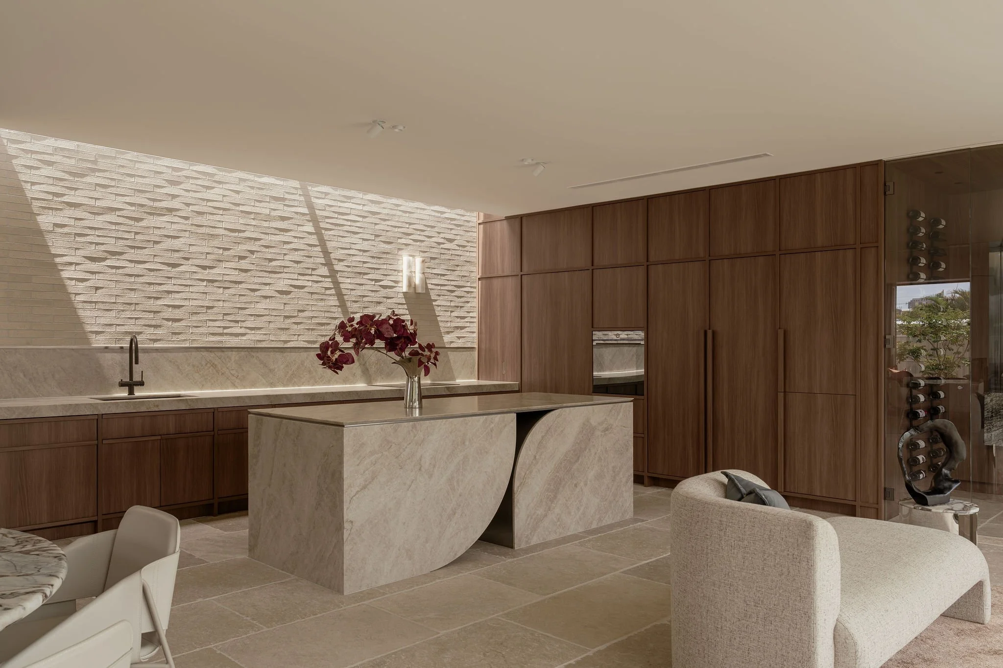 Kitchen and dining at ZOEI seen across the limestone floor.