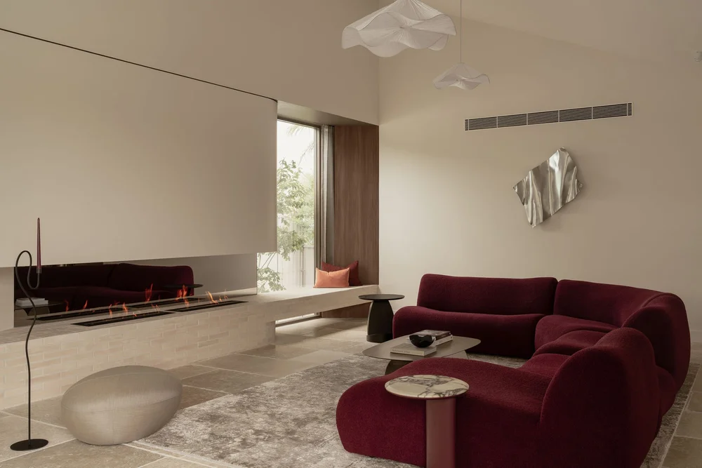 The linear gas fireplace and window seat in the ZOEI living room.
