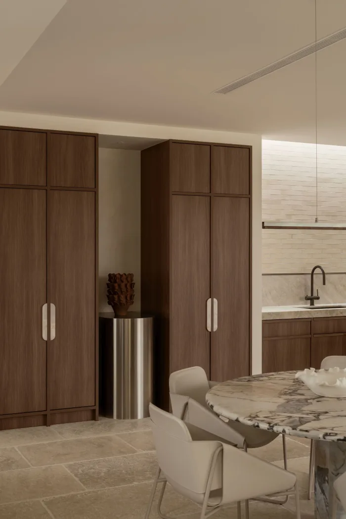 Full height walnut joinery beside the kitchen at ZOEI.