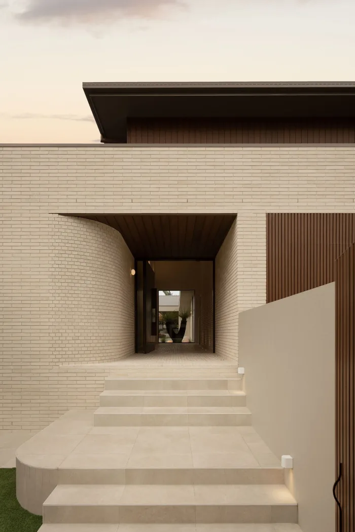 The brick entry tunnel at ZOEI framing the doorway beyond.