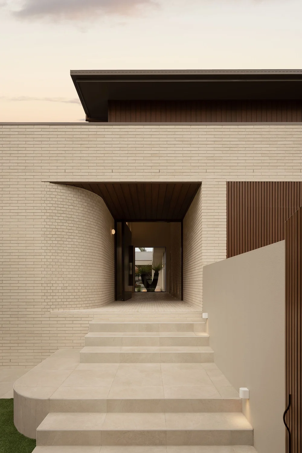The brick entry tunnel at ZOEI framing the doorway beyond.