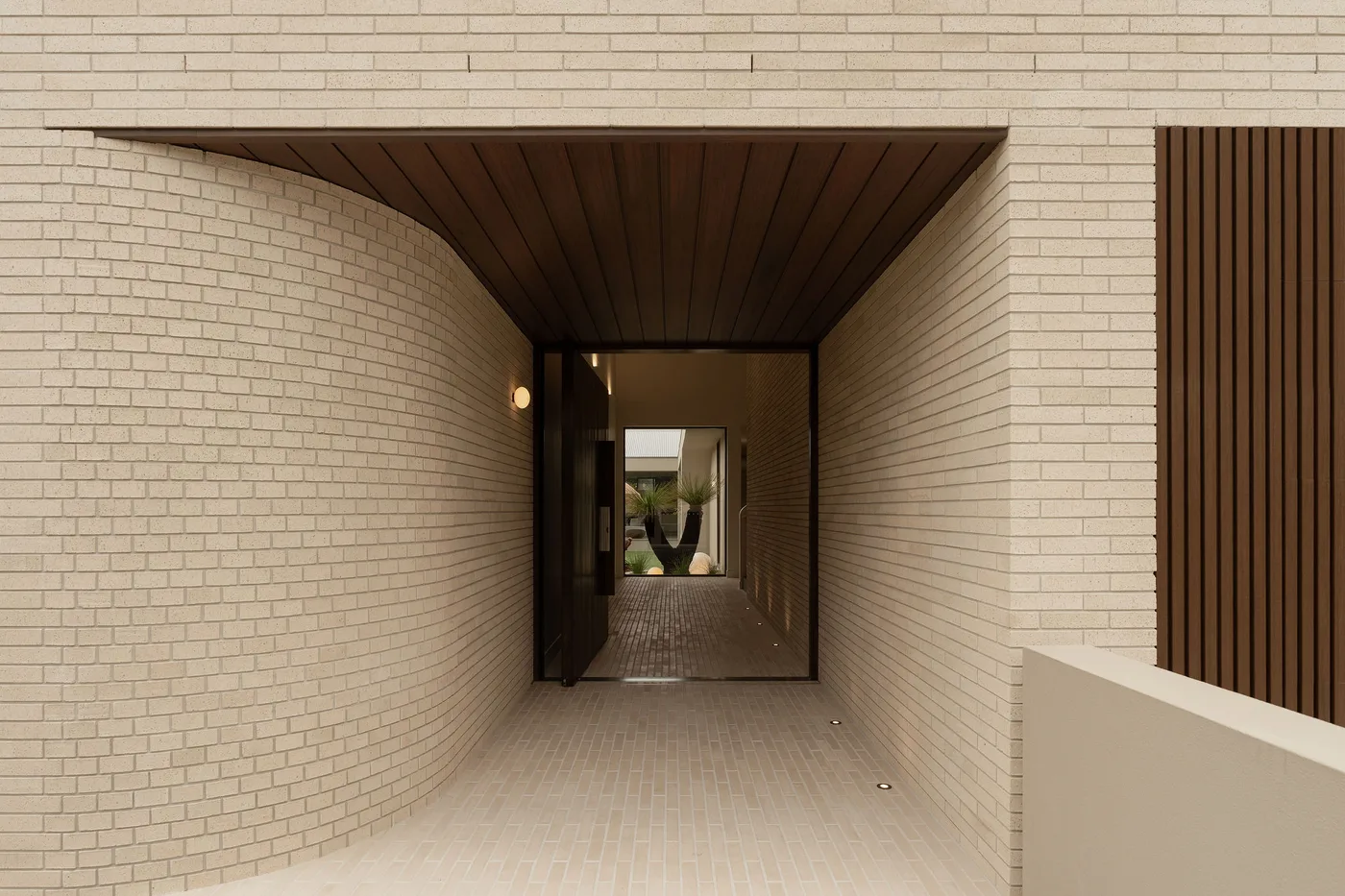 The curved brick entry at ZOEI, a luxury location house available for photoshoot hire on the Gold Coast.