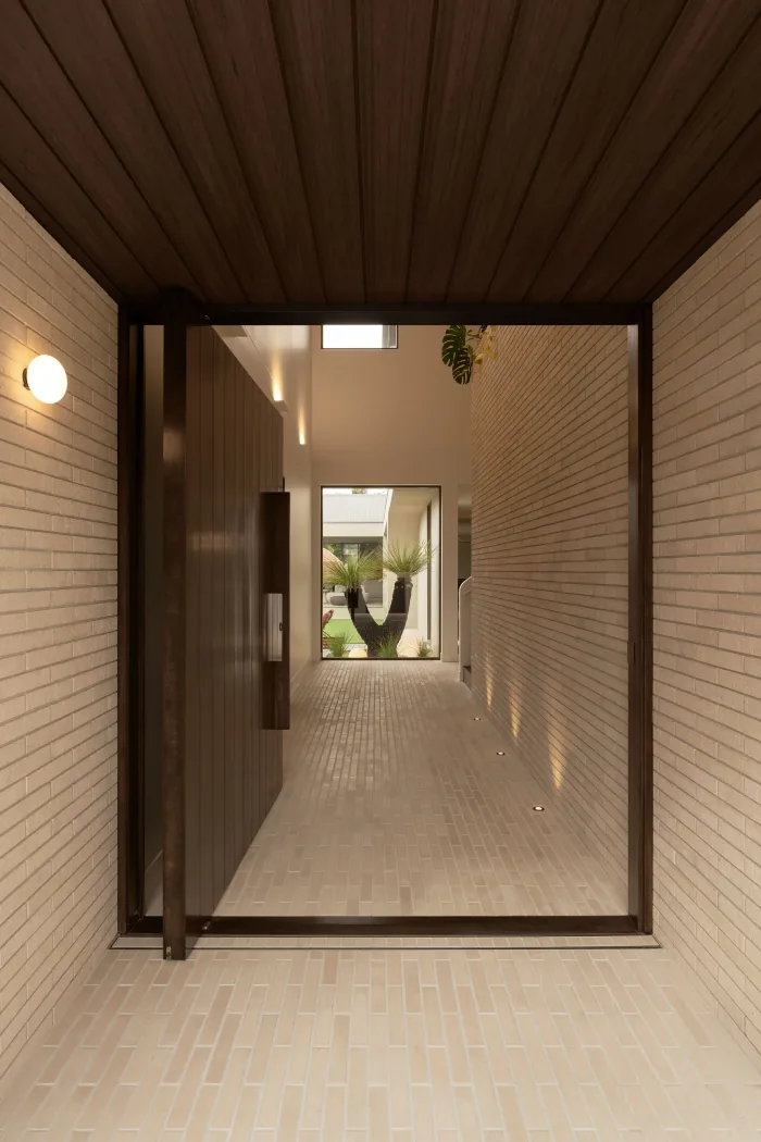 A brick lined corridor opening to the courtyard at ZOEI.