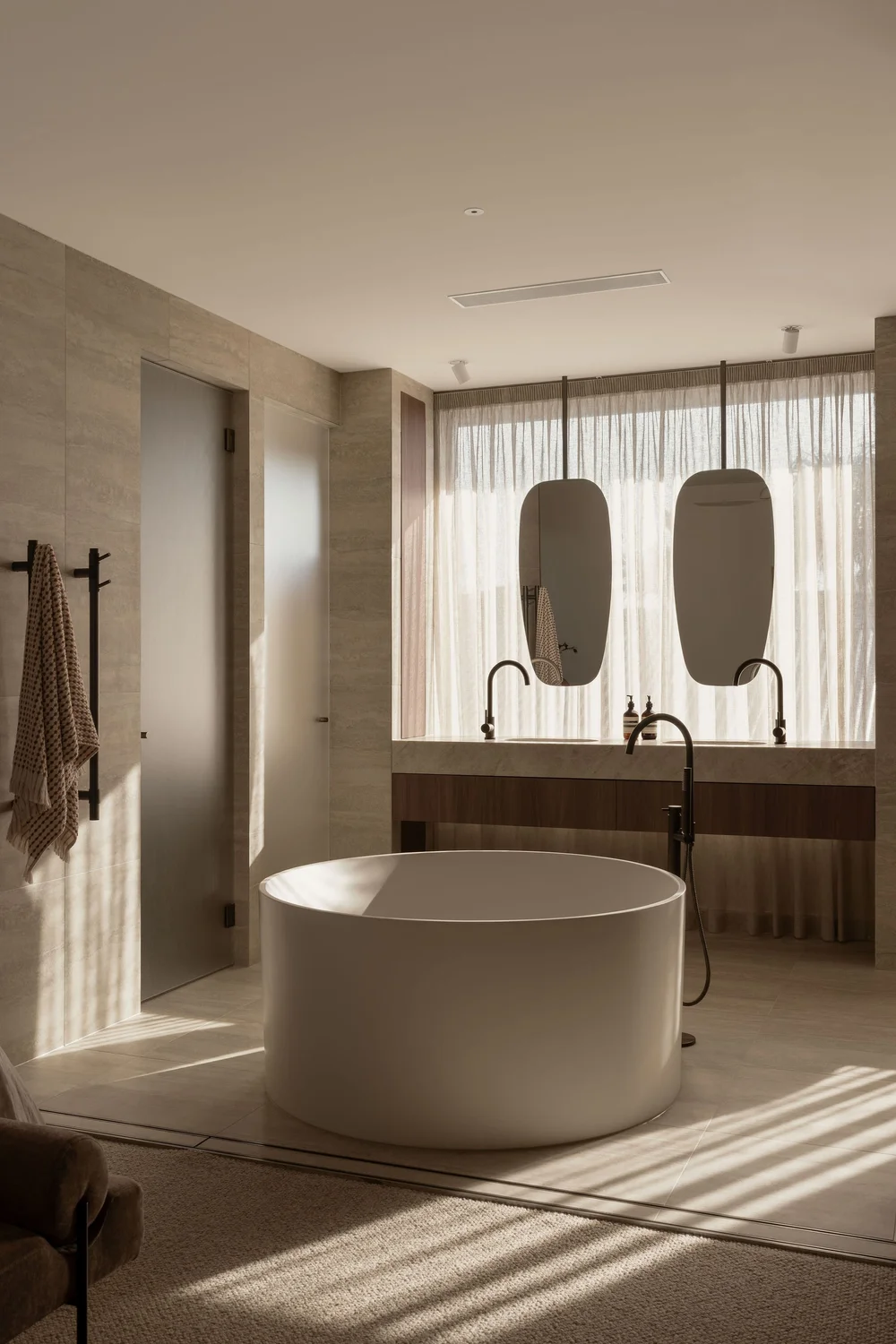 Morning light across the freestanding bath in the ZOEI ensuite.