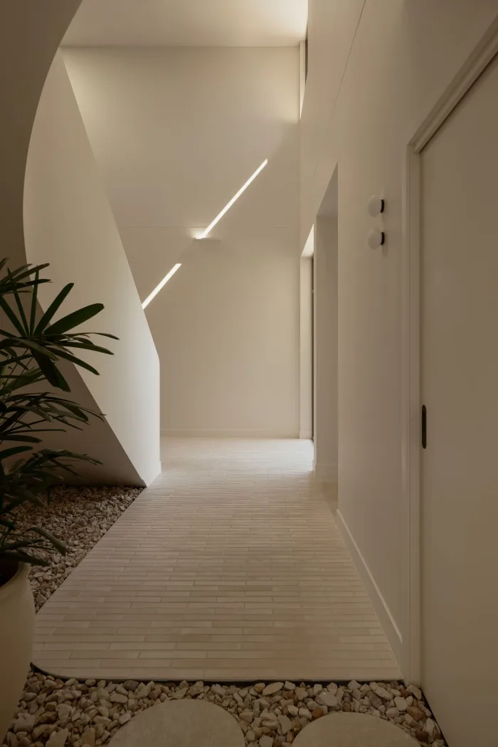 A sculptural corridor opening to planting at ZOEI.