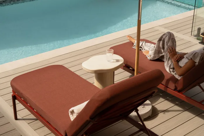 A terracotta sun lounger beside the pool at ZOEI.