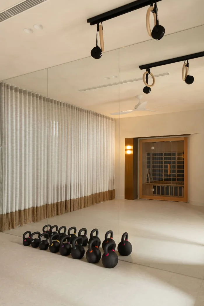 The gym at ZOEI with kettlebells and sheer curtains, included only in Full House.