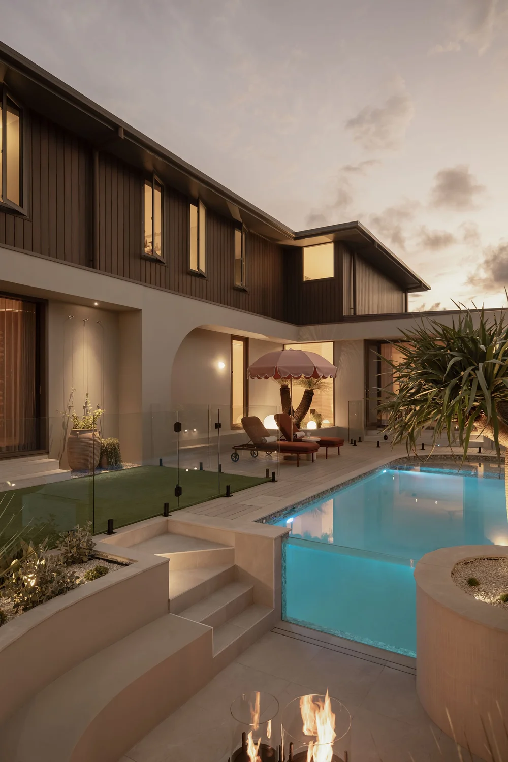 The pool at ZOEI lit at dusk, with the architecture of the house behind it.
